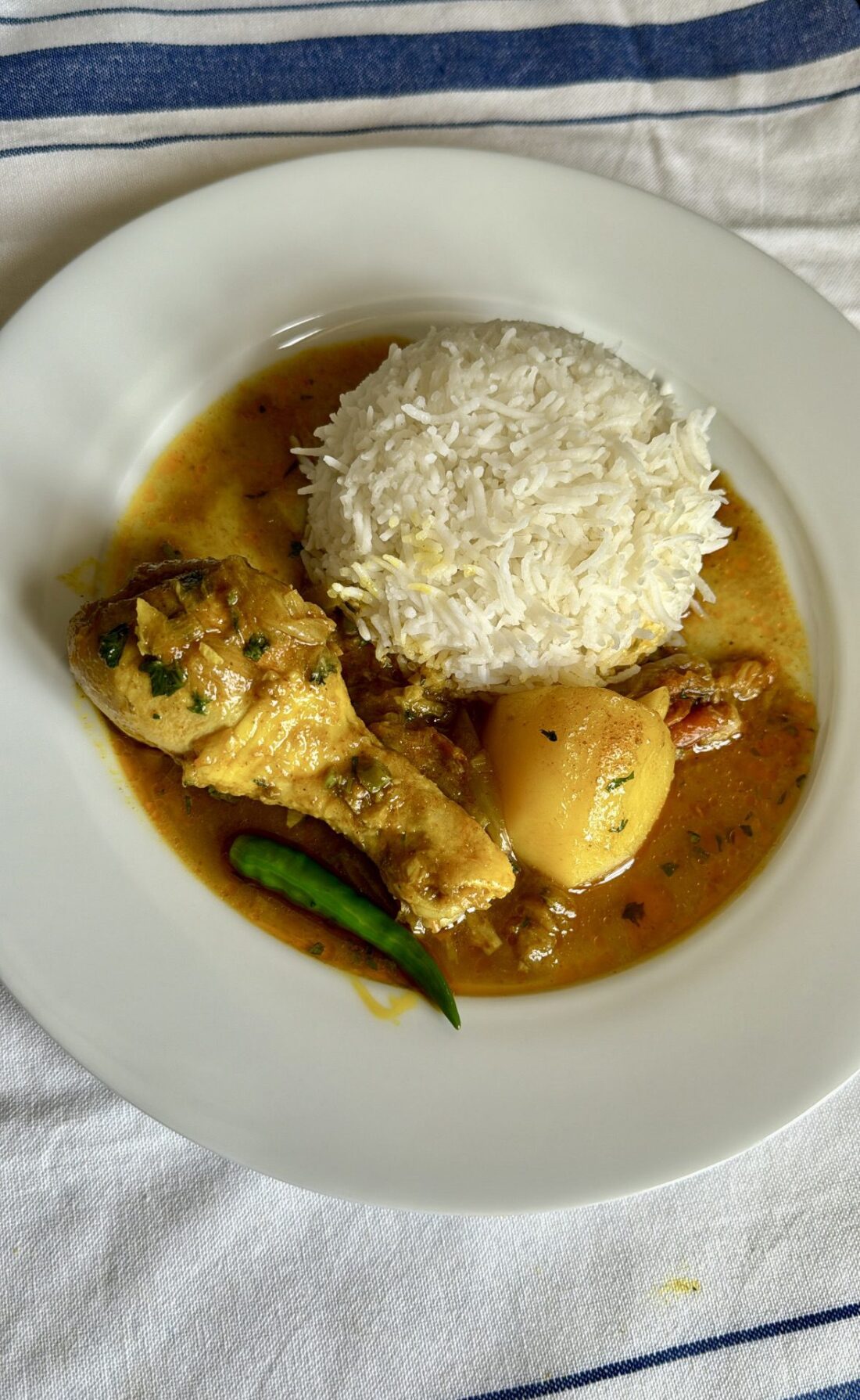 Chicken drumstick curry and rice on a plate