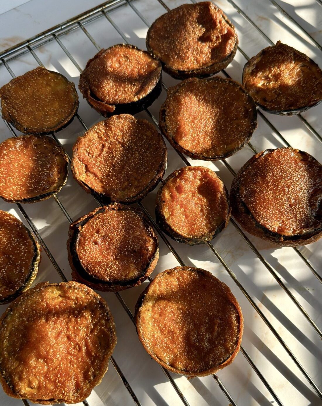 Fried aubergine resting on an oven rack