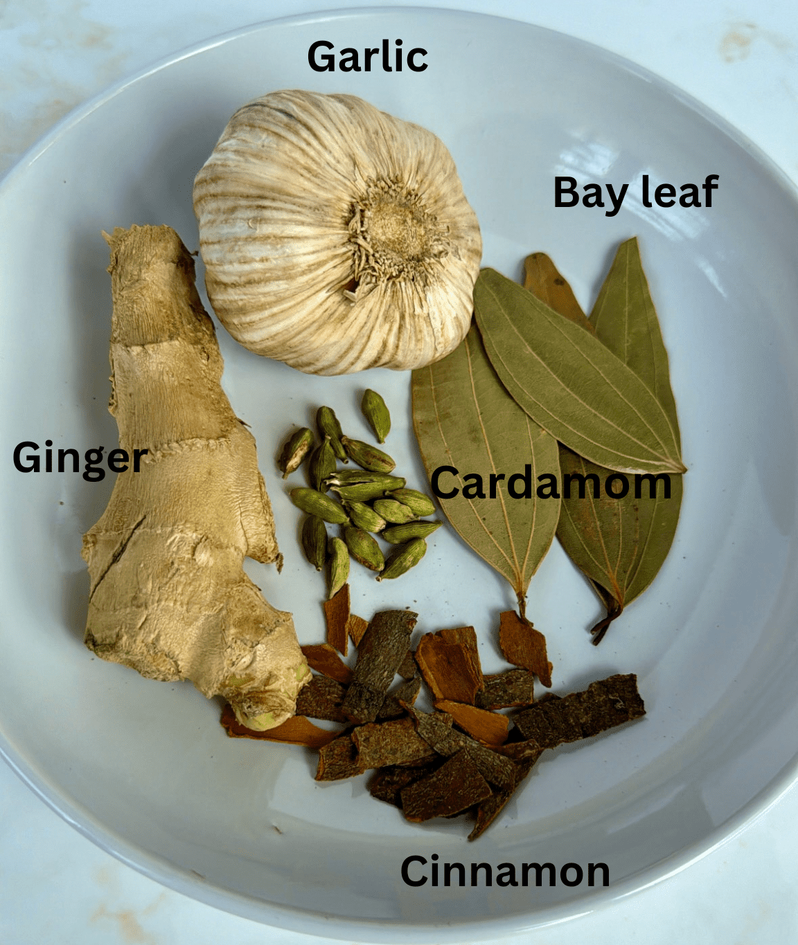 whole garlic head, ginger, bayleaf, cinnamon and cardamom cloves