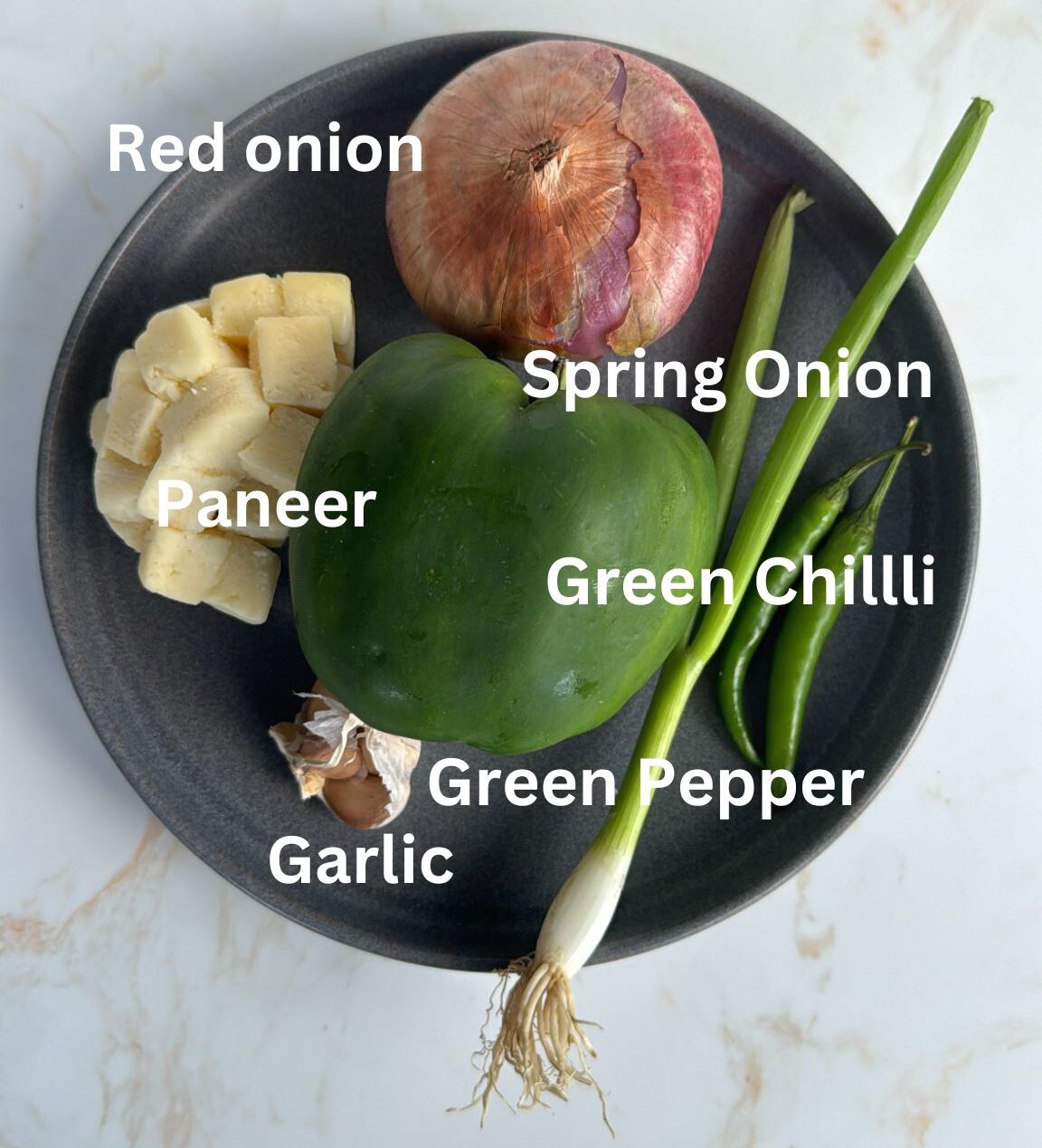 Picture of chilli paneer ingredients, onion, paneer, garlic, spring onion