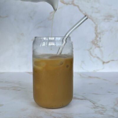 milk being poured to iced tea