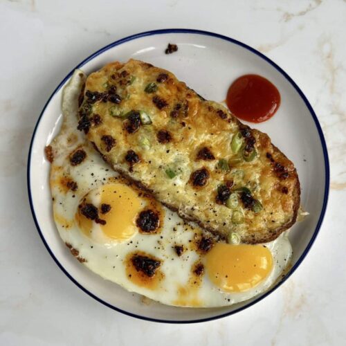 Eggs and cheese toast topped off with chilli and chilli oil