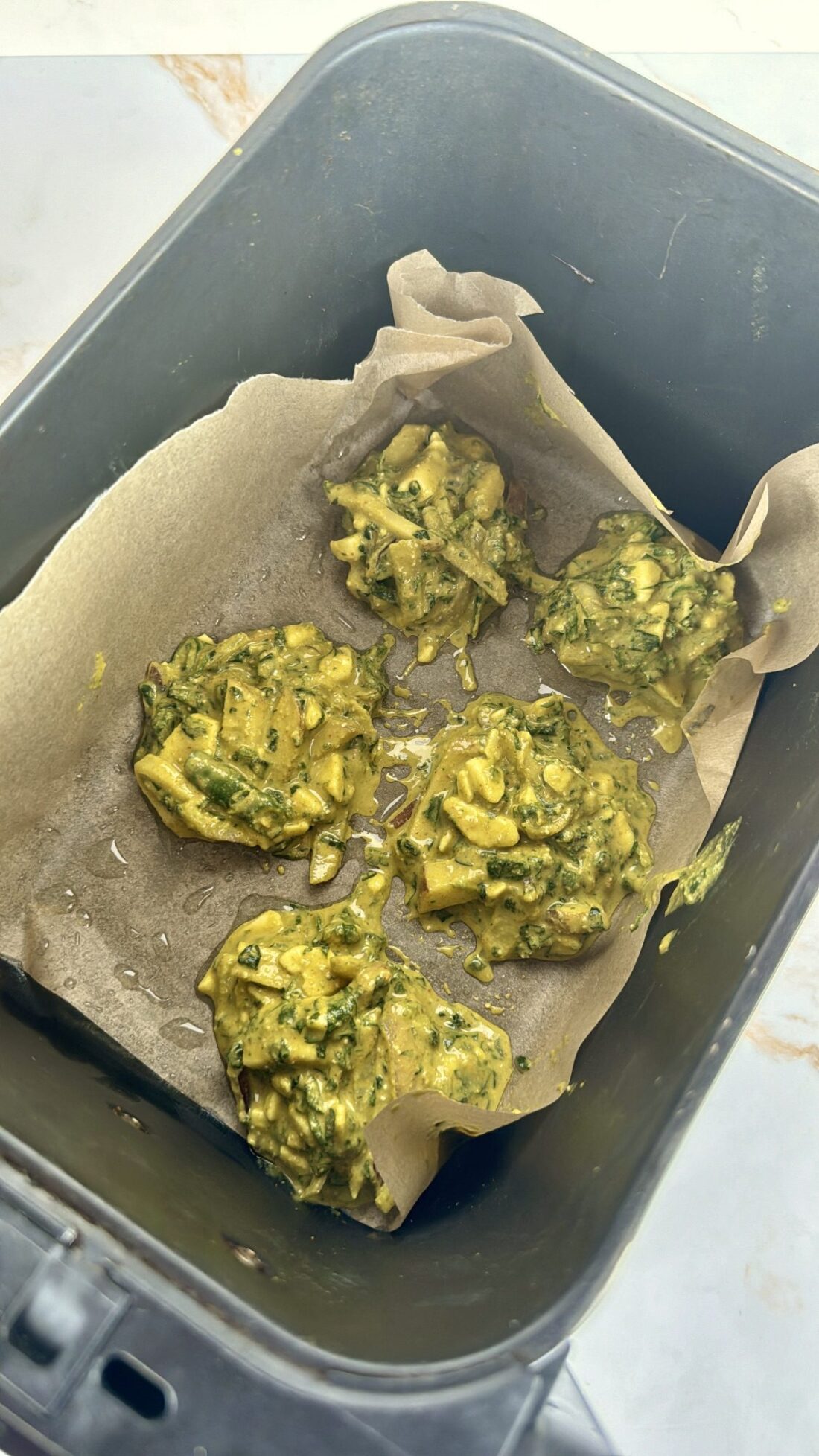 uncooked pakora balls in air fryer