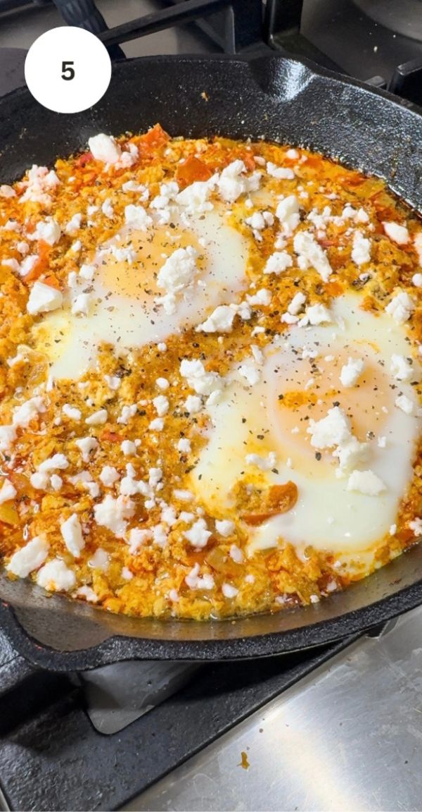 crumbled feta on top of eggs and shakshuka mix