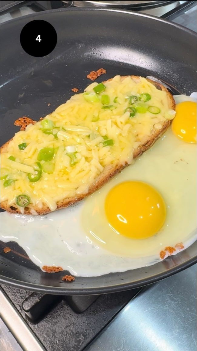 melted cheese with two eggs cracked on the side