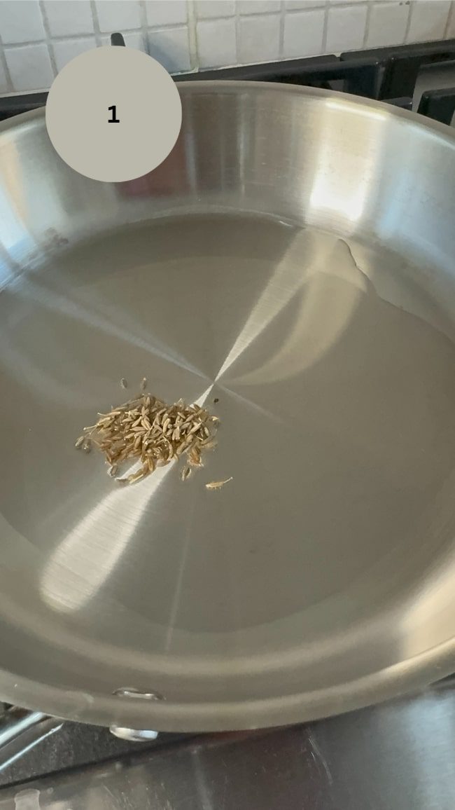 cumin seeds in pan with oil