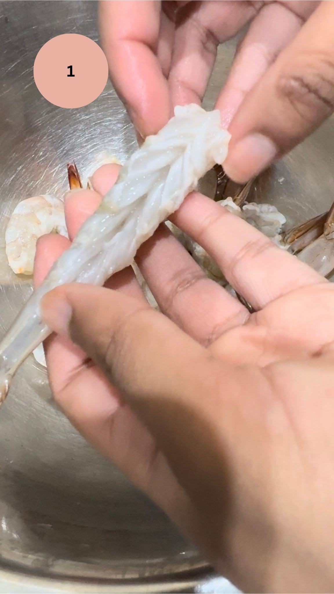 hands holding clean and de veined prawn