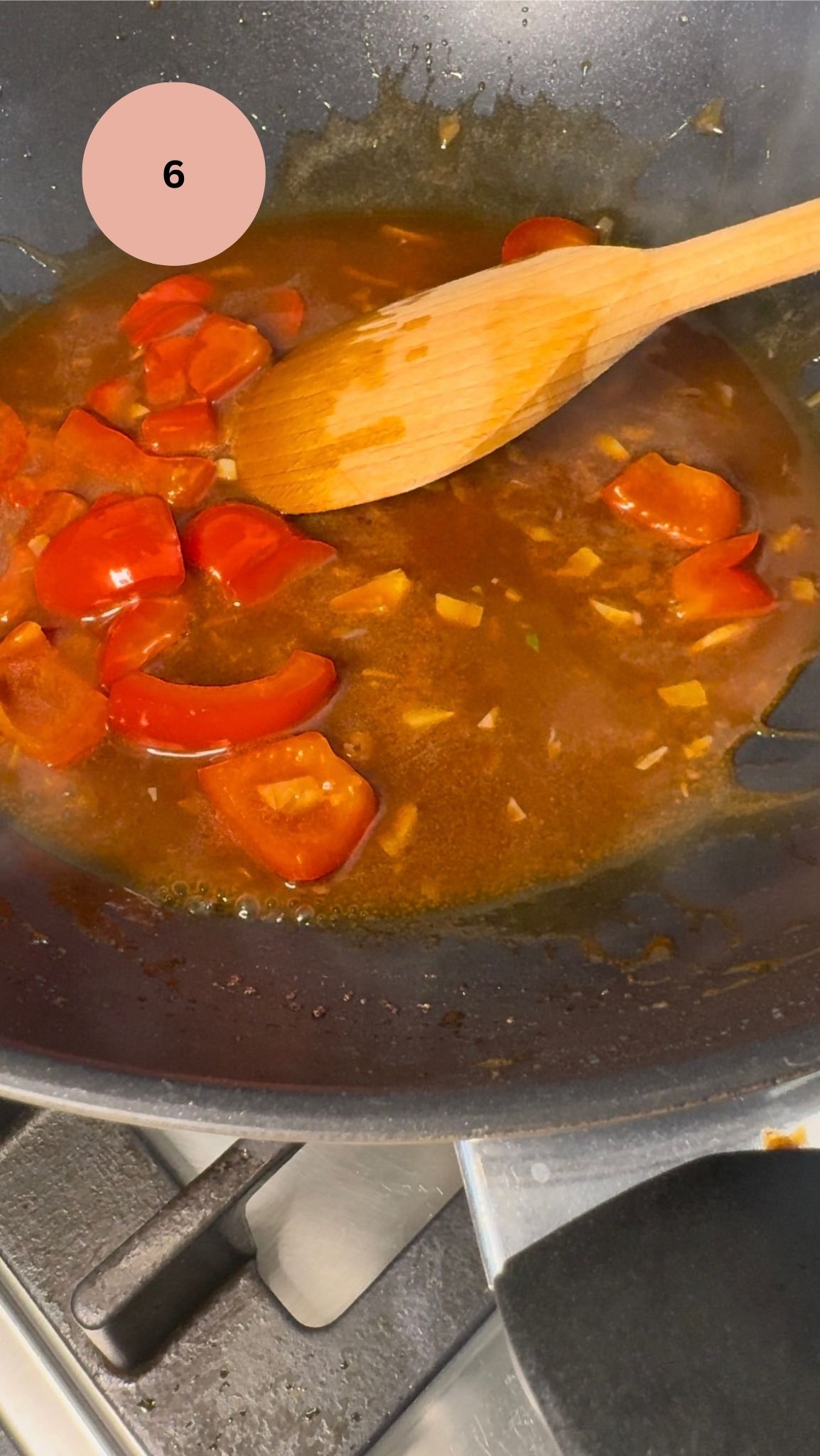 garlic, peppers and sauce added to wok