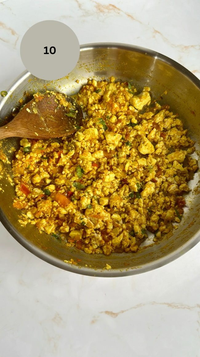 tofu scramble in stainless steel pan with spoon