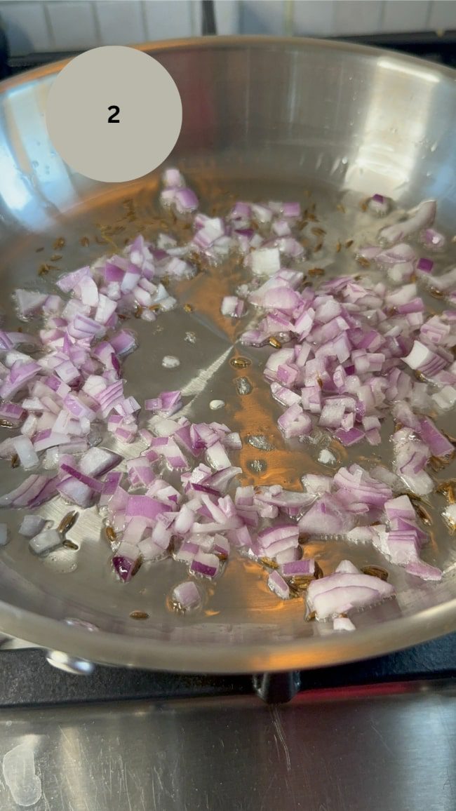 red onions frying in pan