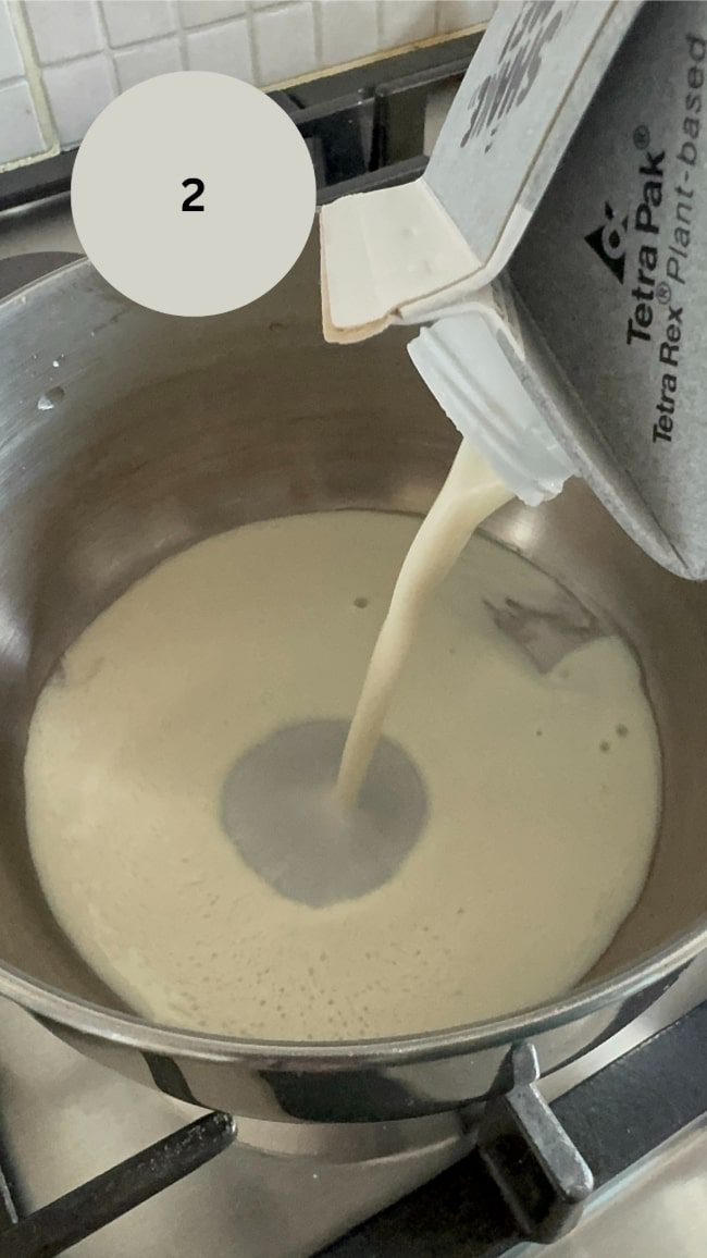 milk being poured into saucepan