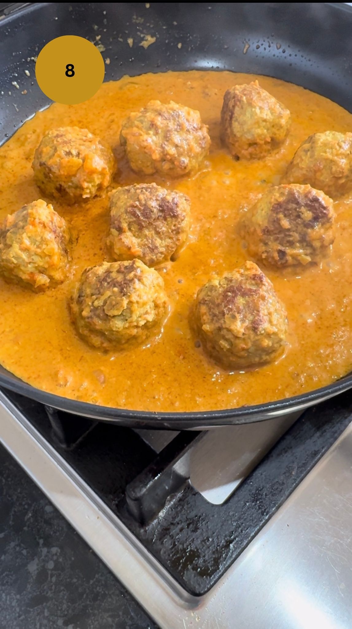 kofta balls added to gravy and coated in the sauce