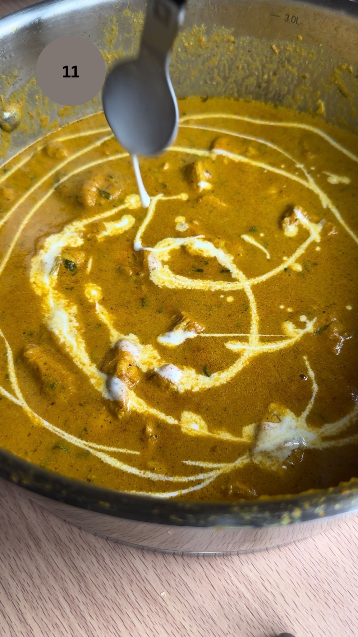 butter chicken garnished with more cream in circles