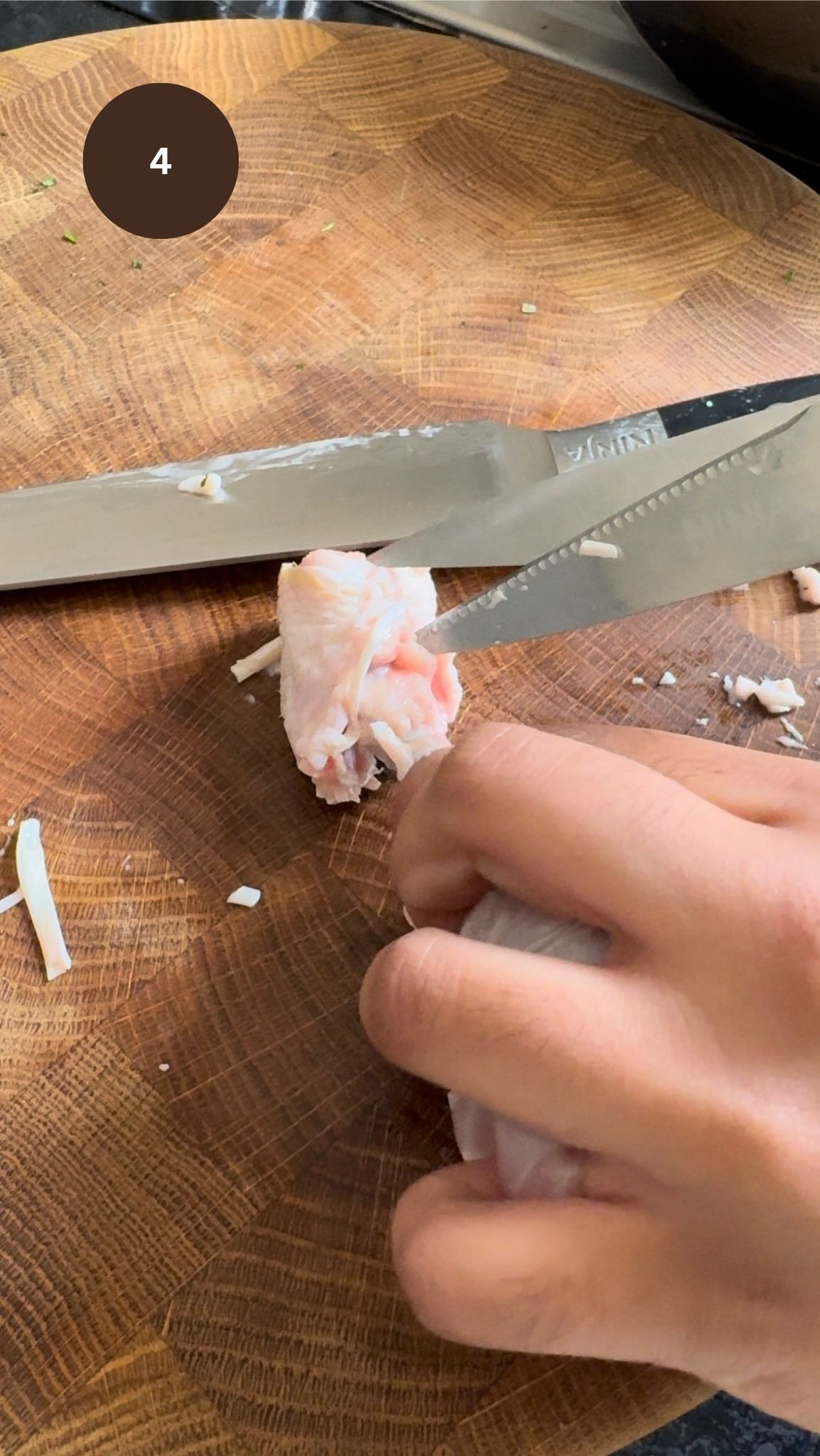 knife cutting bottom of chicken drumstick