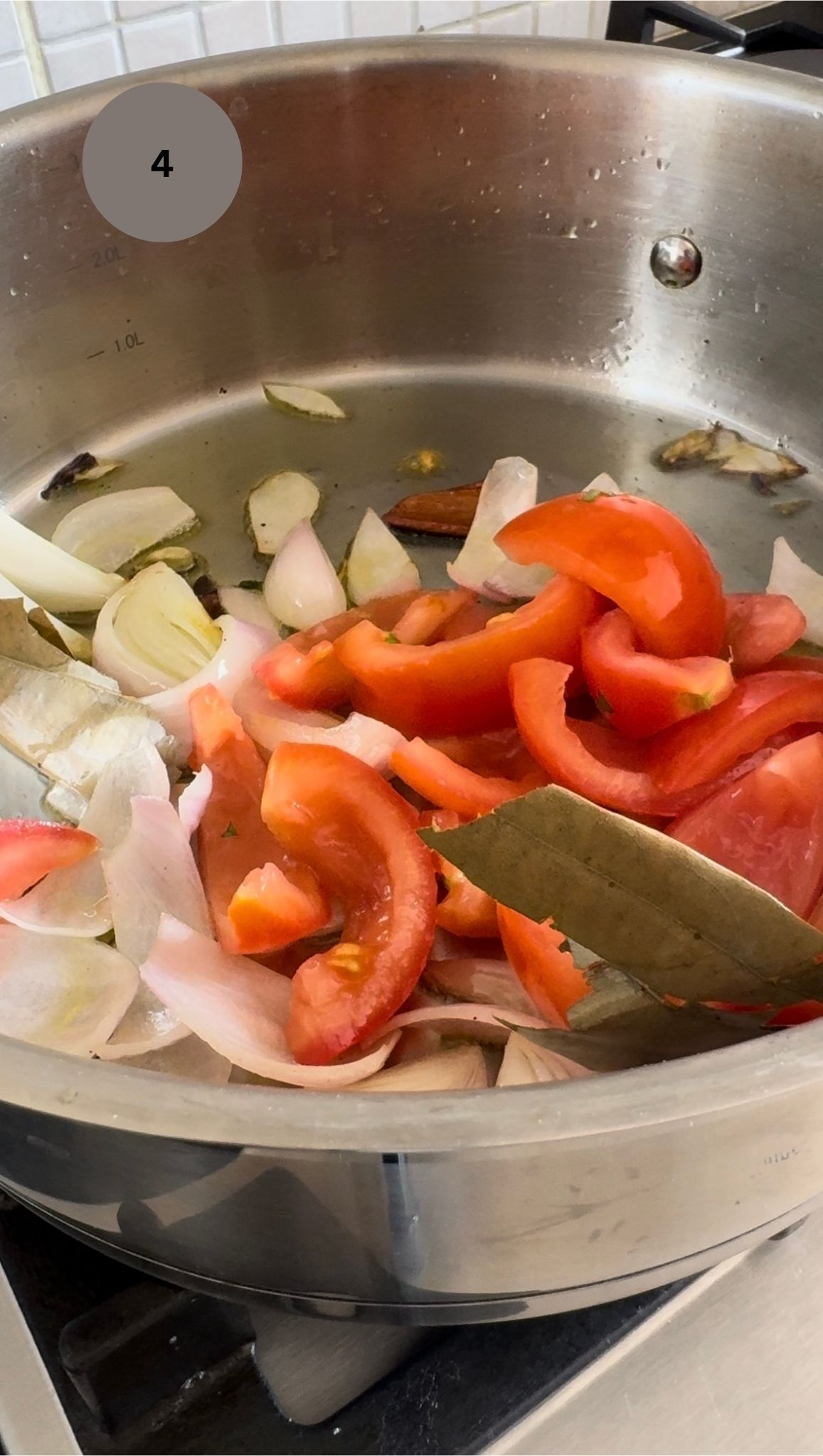 tomatoes added to onions and aromatics