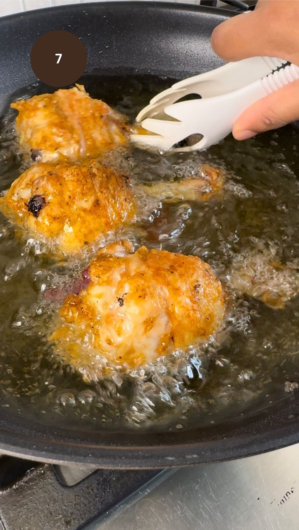 chicken drumsticks flipped over on other side. Drumsticks are golden coloured and crispy