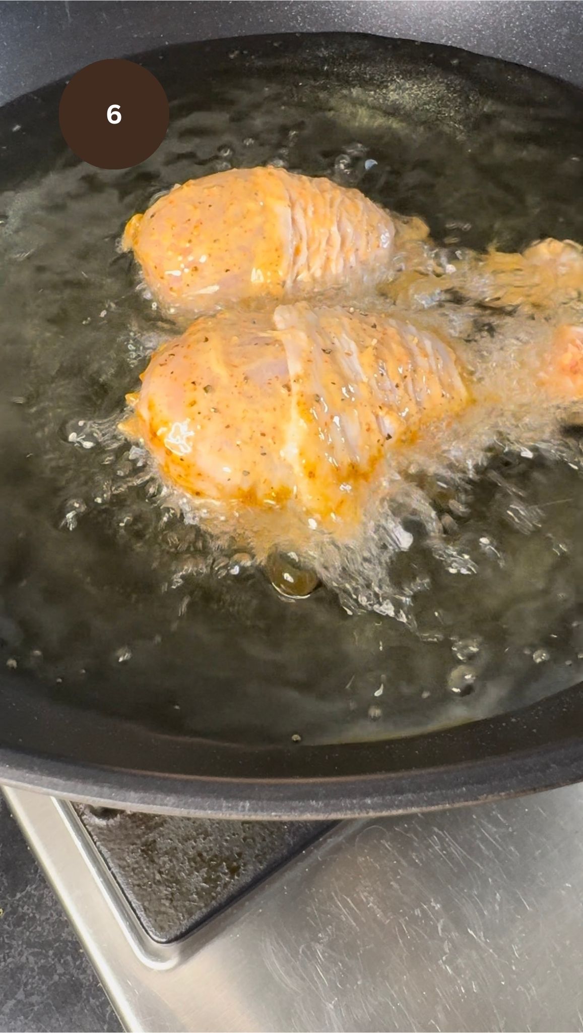 raw chicken in wok frying