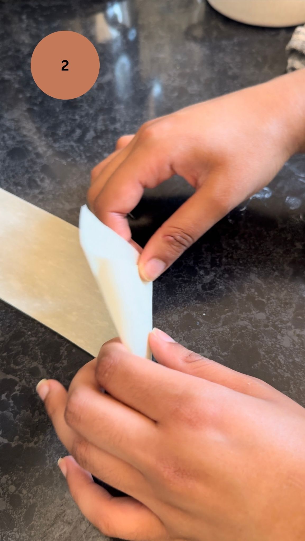 folding the corner on itself to create a cone for filling