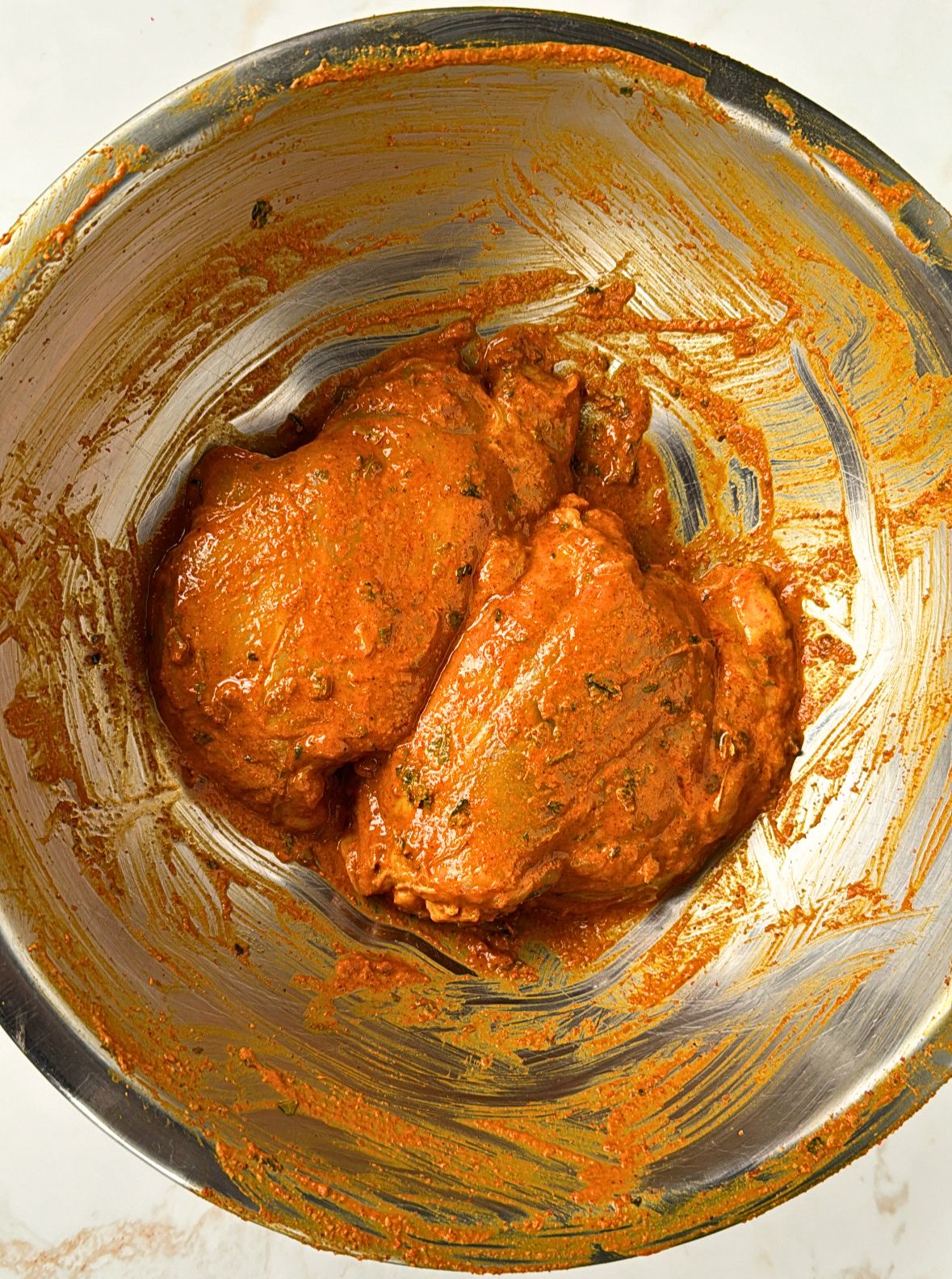 marinated tandoori chicken in steel bowl