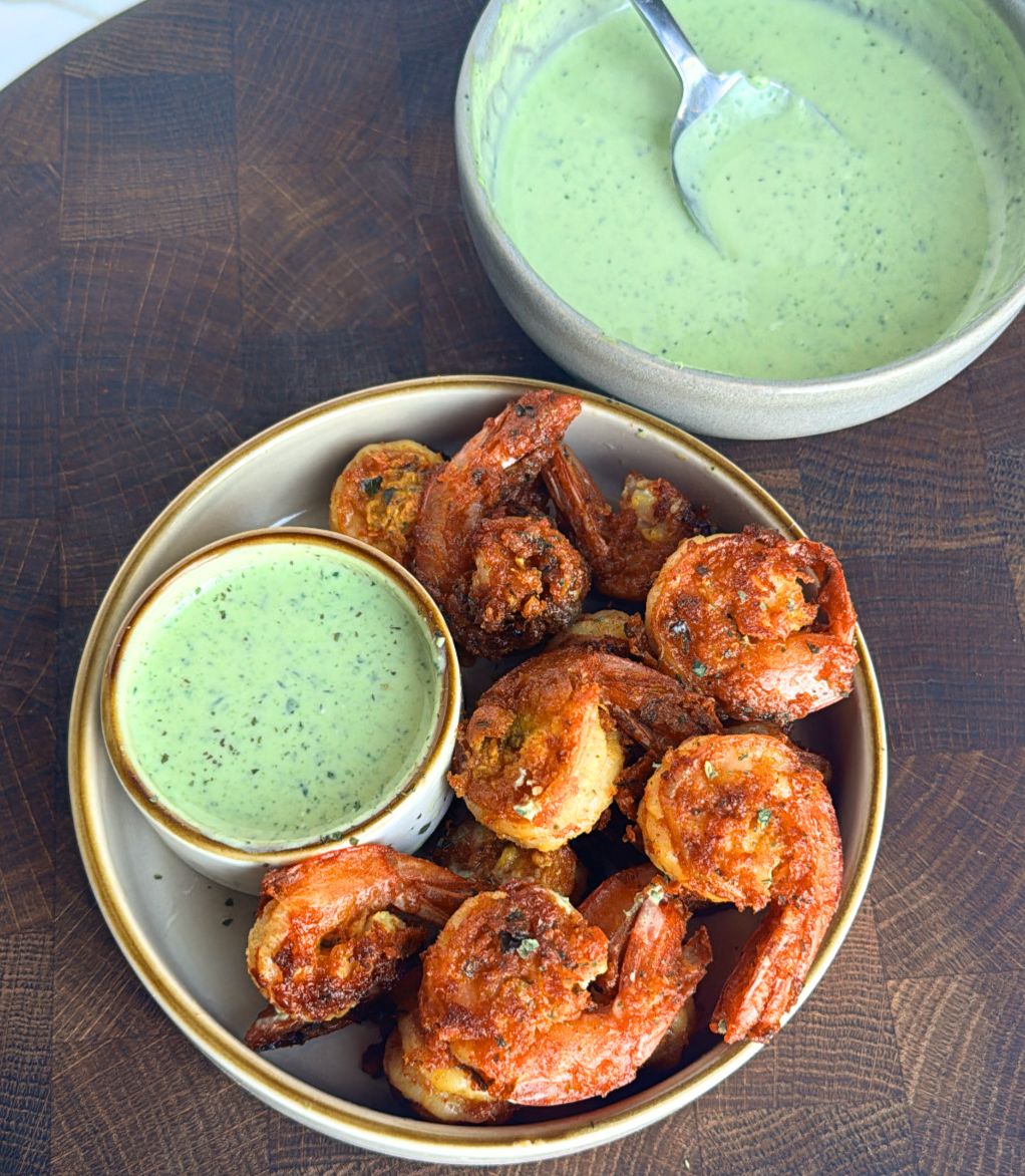 Prawn koliwala on a plate with chutney on the side