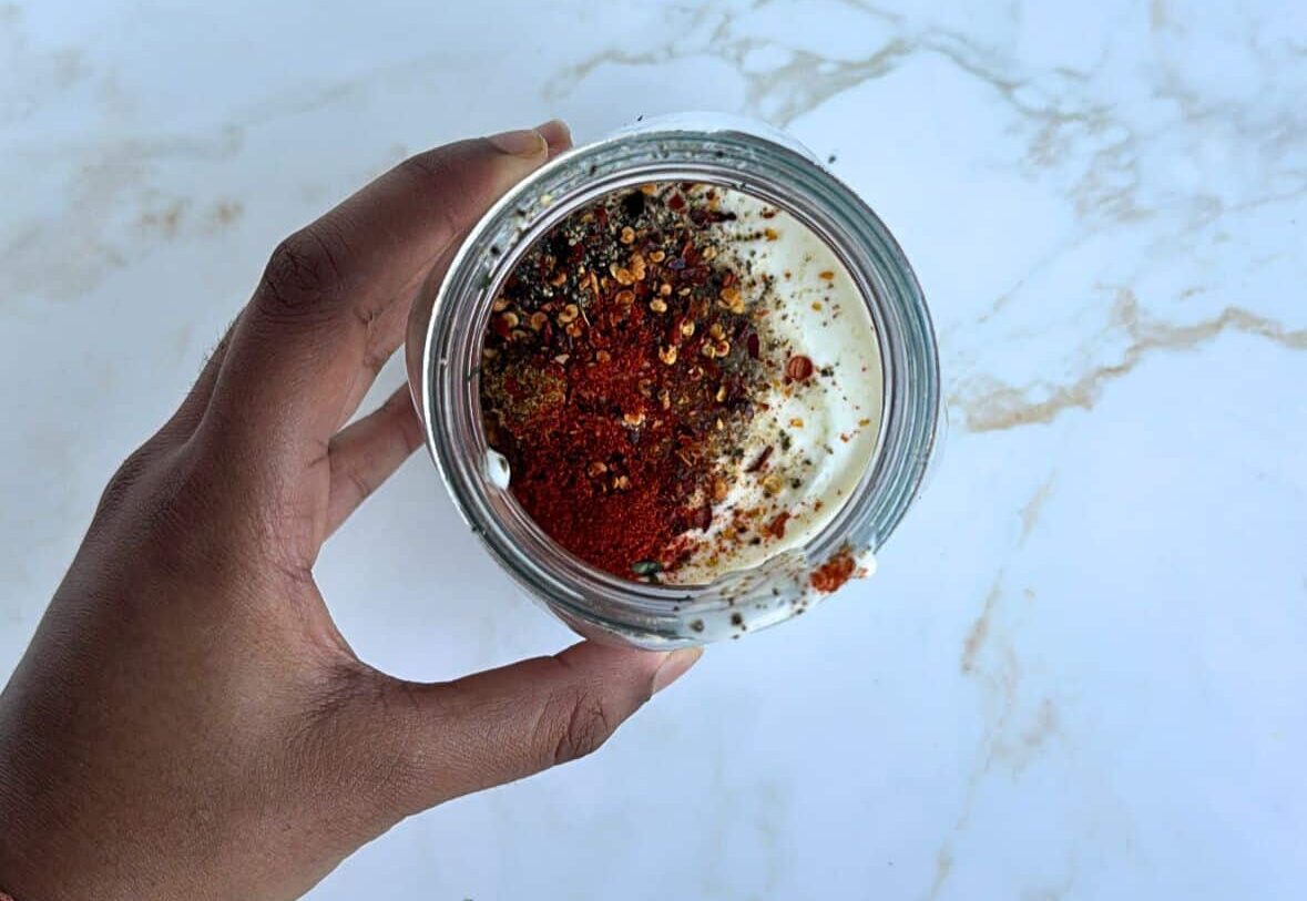 yoghurt in jar topped with spices (unmixed)